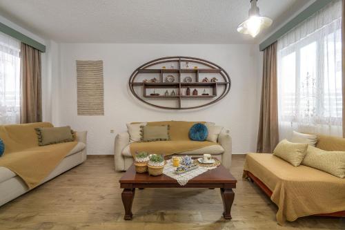 a living room with two couches and a coffee table at Casa Dell Artista with private jacuzzi in Kos Town
