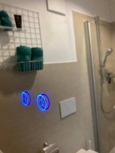 a bathroom with a shower with blue lights on the wall at Gästehaus Geiseltalsee in Mücheln