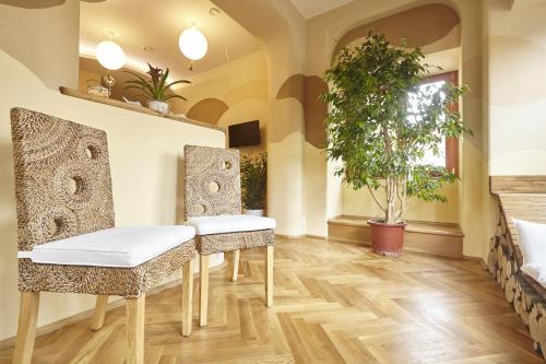 a dining room with two chairs and a table at Wellness Apartment De Luxe in Liberec