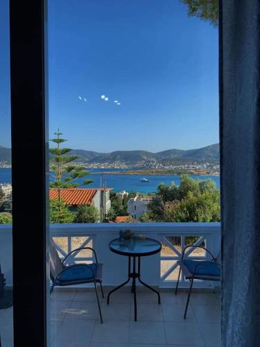 a balcony with a table and chairs and a view of the water at Studio with unique view near the beach! in Porto Rafti