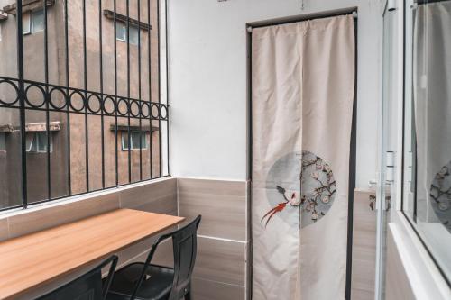 a dining room with a table and a window at Indochine Design Apartment Hotel 5 - Hanoi Old Quarter in Hanoi