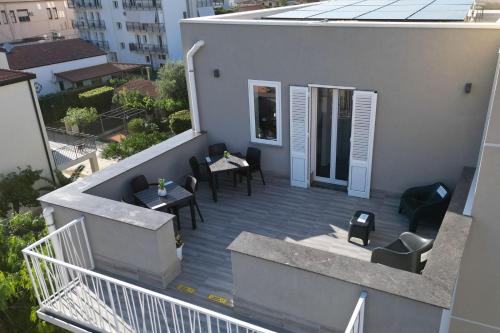 a balcony with tables and chairs on a building at Da 'Nfacci Affittacamere in Carini
