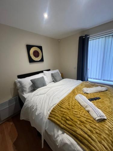 a bedroom with a large bed with towels on it at Shared Room in Ashton under Lyne