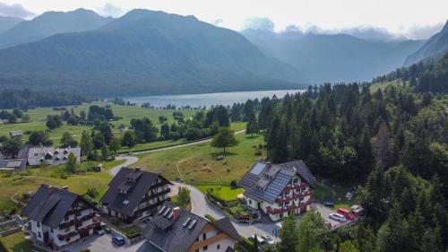 an aerial view of a resort with a lake and mountains at Apartmaji Vesna in Bohinj