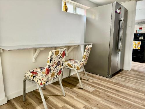 a kitchen with a chair and a counter and a refrigerator at Private Room with Shared Bathrooms 10 Minutes To SeaTac Airport in Seattle