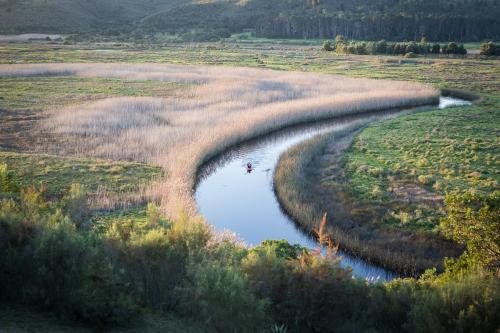 an aerial view of a river in a field at Emily Moon River Lodge in Plettenberg Bay