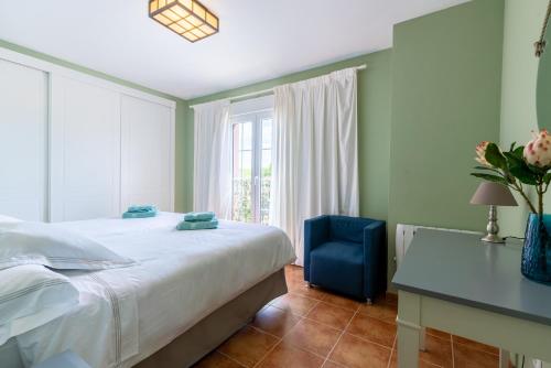 a bedroom with a bed and a desk and a window at LA QUINTA ISLA CANELA GOLF by MSHOLIDAYS in Isla Canela