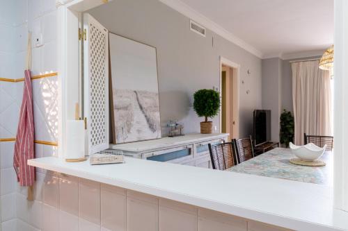 a living room with a large mirror and a table at LA QUINTA ISLA CANELA GOLF by MSHOLIDAYS in Isla Canela