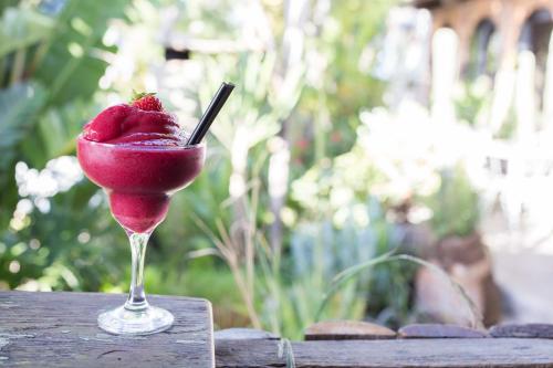 a red drink in a glass on a table at Emily Moon River Lodge in Plettenberg Bay
