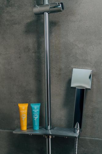 a shelf with three different colored cups on it at Apolithon Premium Houses in Sígrion