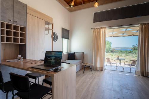 an office with a desk with a laptop on it at Apolithon Premium Houses in Sígrion
