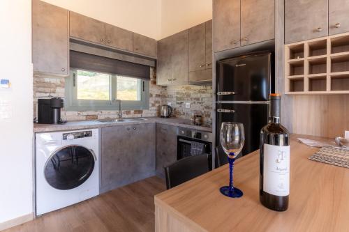 a bottle of wine sitting on a wooden table in a kitchen at Apolithon Premium Houses in Sígrion