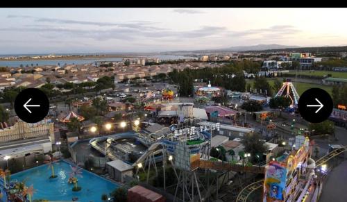 an amusement park with a roller coaster and rides at Chez nous in Fleury