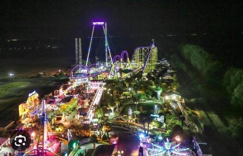 an amusement park at night with a roller coaster at Chez nous in Fleury