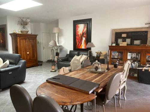 un salon avec une table et des chaises en bois dans l'établissement Villa Saint Marc Jaumegarde proche de la Sainte Victoire, à Saint-Marc-Jaumegarde
