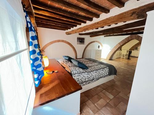 a bedroom with a bed in a room with wooden ceilings at Gli archi nel cuore di Siena in Siena