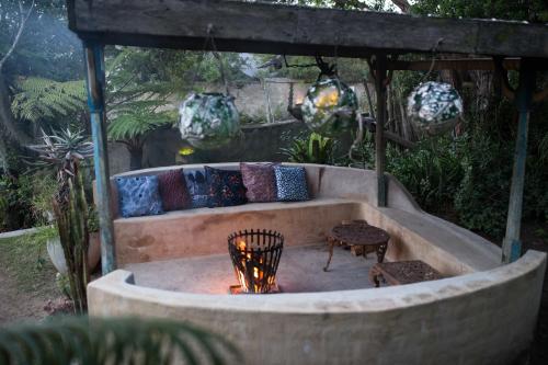 a fire pit in the middle of a garden at Emily Moon River Lodge in Plettenberg Bay