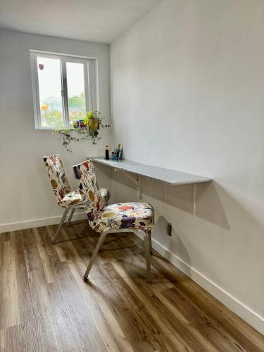 a room with a desk and a chair and a window at Cozy Private Room with Shared Bathroom on the 1st Floor - Conveniently Located near SeaTac Airport and Downtown in Seattle