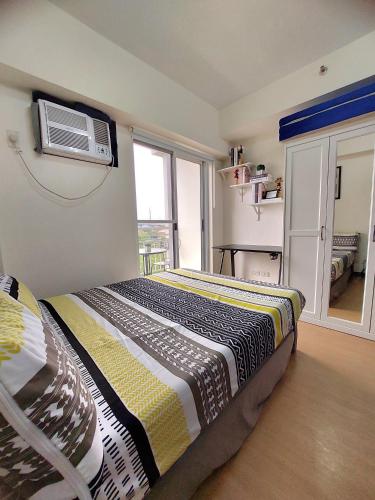 a bedroom with a bed and a air conditioner on the wall at Casa Concha in Manila