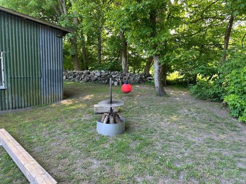 a red ball sitting on top of a fire pit at Solbjerg Skov B&B in Solbjerg