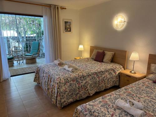 a hotel room with two beds and a balcony at Ocean View near the Beach Costa Adeje in Adeje