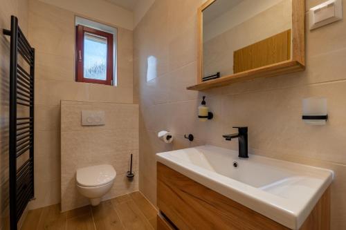 a bathroom with a sink and a toilet at Penzion Fortuna in Liptovský Mikuláš