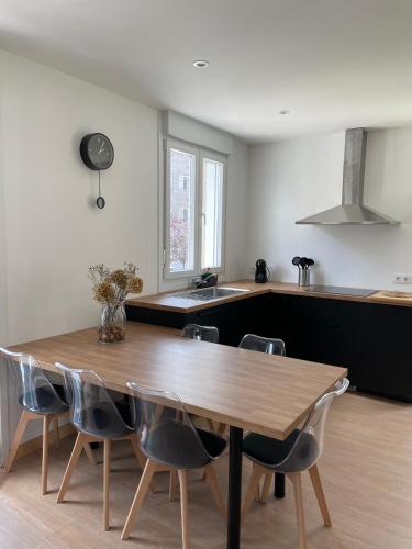 a kitchen with a wooden table and chairs at Apartamentos A Xunqueira in Redondela
