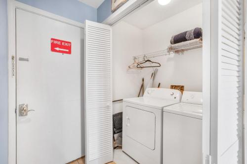a white laundry room with a washer and dryer at Sea Oats 102C- Beach view Pool 25 steps to beach in Gulf Shores