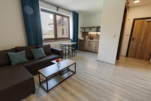 a living room with a couch and a table at Penzion Kamence in Liptovský Mikuláš