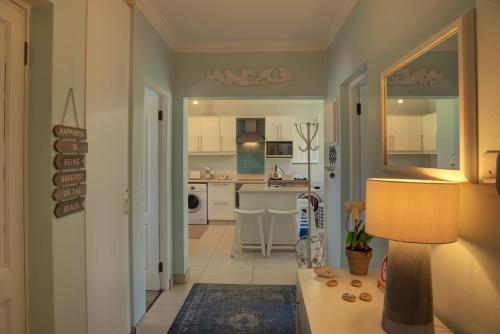 a hallway with a kitchen and a living room at Keurbooms River Lodge 21 in Keurboomstrand
