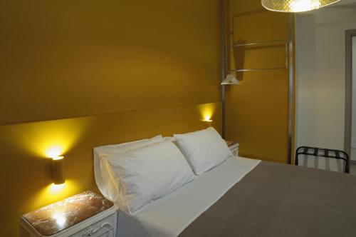 a bedroom with a bed with white pillows on it at B&B Sbarco dei 1000 Marsala in Marsala