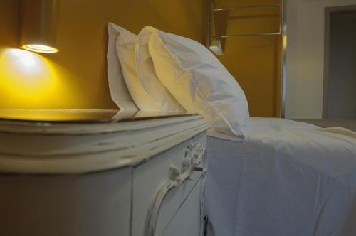 a bed with white pillows on top of it at B&B Sbarco dei 1000 Marsala in Marsala