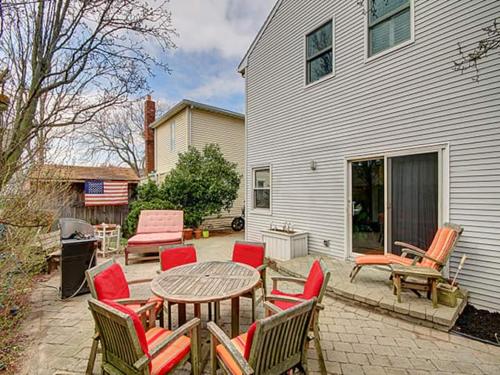 a patio with a wooden table and chairs and a table at Atlantic Beach Paradise - Quiet Beach Sanctuary in Atlantic Beach