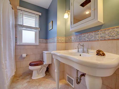 a bathroom with a sink and a toilet at Atlantic Beach Paradise - Quiet Beach Sanctuary in Atlantic Beach