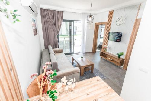 a living room with a couch and a table at Bumax Apartments in Ulcinj