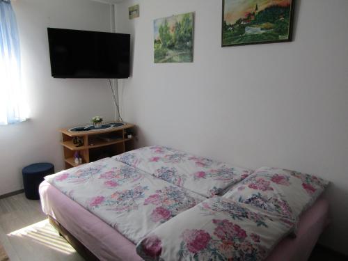 a bedroom with a bed and a flat screen tv at Kuca za odmor Mare in Sveti Martin na Muri