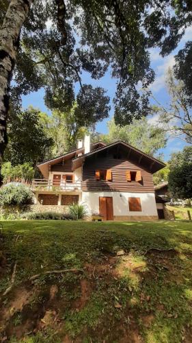 a house that is sitting in the grass at Refúgio do Selado in Monte Verde
