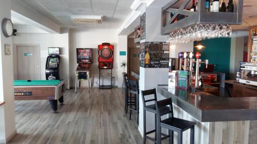 a bar with a pool table and arcade machines at Te Maná Hotel in Torreblanca