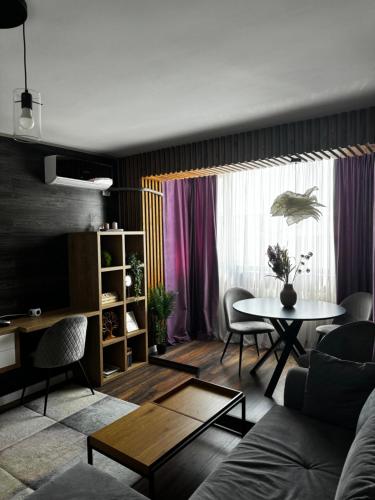 Lovely 2 Rooms apartment in the CENTER of the city في بوخارست: غرفة معيشة مع أريكة وطاولة