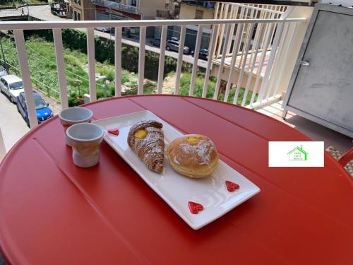 a red table with a plate of pastries on it at Casa Lavi Rapallo in Rapallo