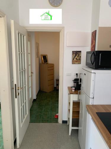 a kitchen with a refrigerator and a microwave at Casa Lavi Rapallo in Rapallo