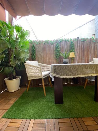 een patio met een tafel, stoelen en planten bij Studios with Mezzanine Rua da Moeda in Lissabon