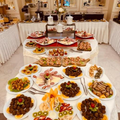 a table with many plates of food on it at Hotel Fieri in Fier