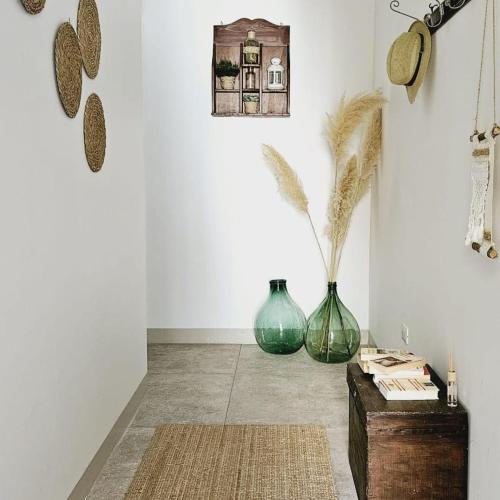 two green vases sitting on the floor in a room at Nel Borgo di San Francesco - Casa vacanze in centro in Villa Santa Maria