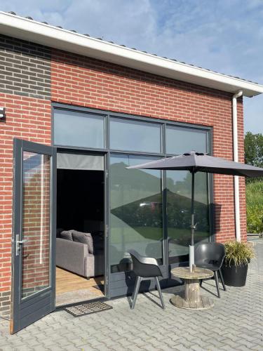 a patio with an umbrella and a table and chairs at loods 14 in Groningen