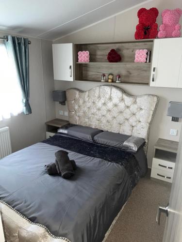 a bedroom with a bed with a stuffed animal on it at Skye Breaks in Sheerness