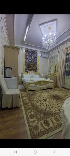 a large bedroom with two beds and a chandelier at UYUT INN Hotel in Samarkand