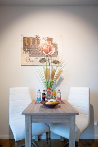 a wooden table with a plate of food on it at Ferienwohnungen - barrierefrei - im sanierten Gutshof in Lalendorf