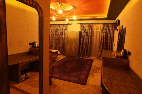 a room with a bathroom with a shower and a chandelier at Ashab-I Kehf Cappadocia House in Nevsehir