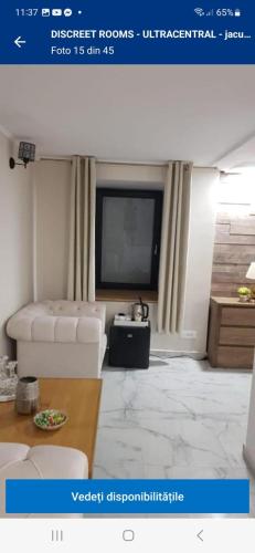 a living room with a white couch and a flat screen tv at IMPERIAL ROOMS - ULTRACENTRAL - jacuzzi cu hidromasaj in Oradea
